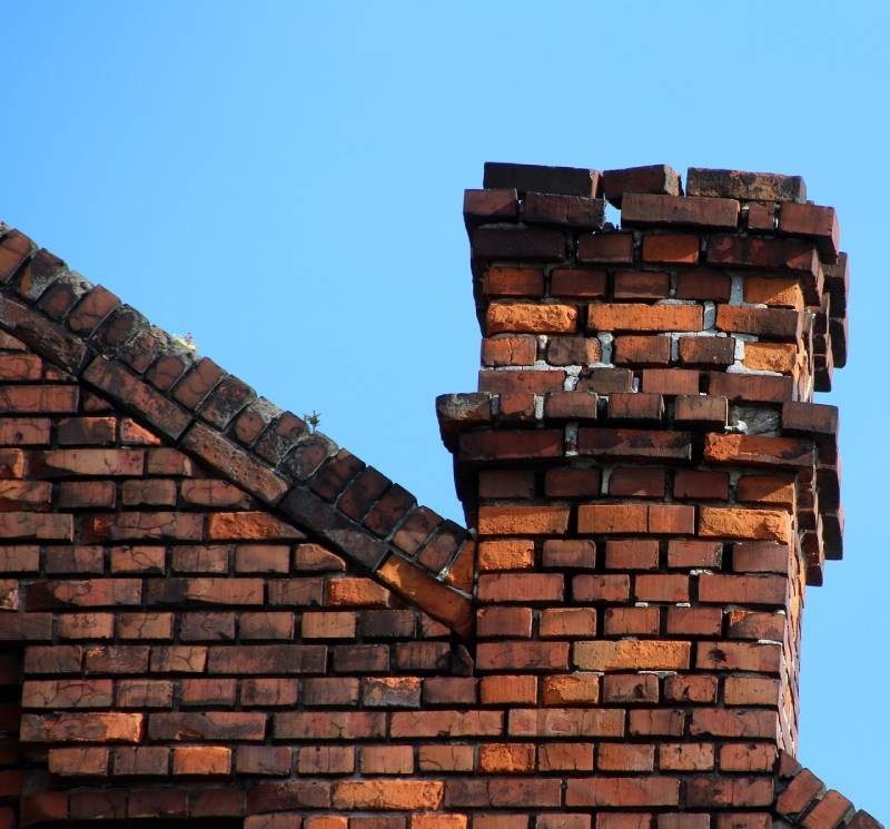 Damaged chimney on an Lake Zurich home showing cracks and missing mortar